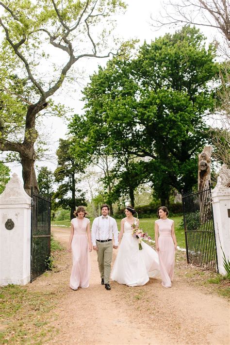Stylish young groom and bride with wedding bouquet standing together in botanical garden. Spring Garden Wedding Inspiration by Nelani Van Zyl ...