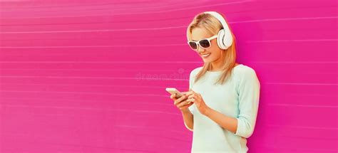 Portrait Of Happy Smiling Young Woman In Headphones Listening To Music