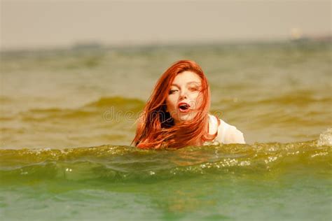 Redhead Woman Playing In Water During Summertime Stock Photo Image Of