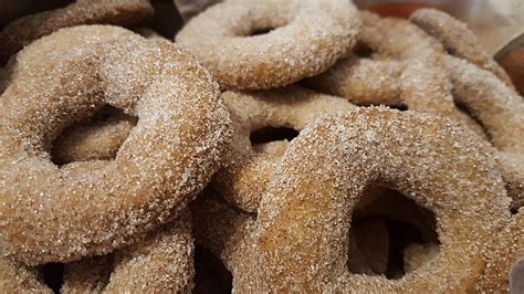 Jelly christmas linzer cookies with orange and red jam on a wooden board with festive decoration. Cinnamon Rings - Austrian German Christmas Cookies • Best German Recipes