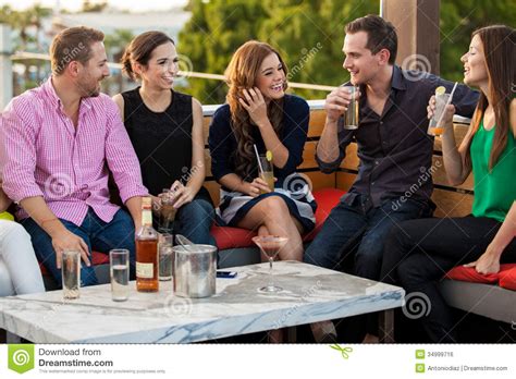 Young Adults Having Drinks At A Bar Stock Photo Image Of