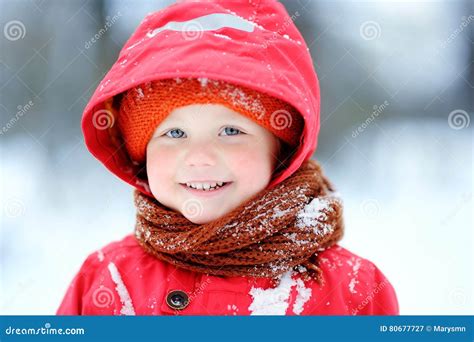 Portrait Of Happy Little Boy In Red Winter Clothes Having Fun During