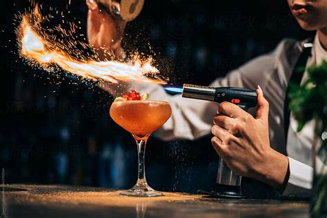 Bartender Spilling And Burning Spices Over Cocktail Del Colaborador