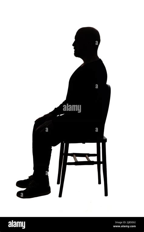 Side View Of Silhouette Of The Man Sitting On Chair Stock Photo Alamy