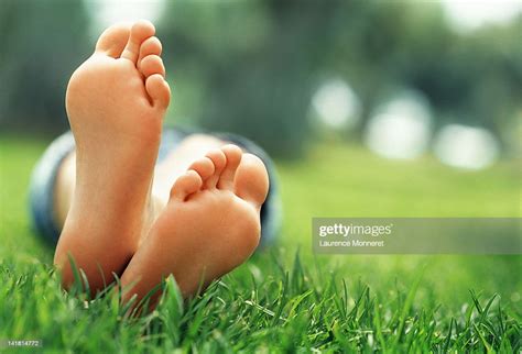 Young Woman Lying In Grass With Crossed Feet Photo Getty Images