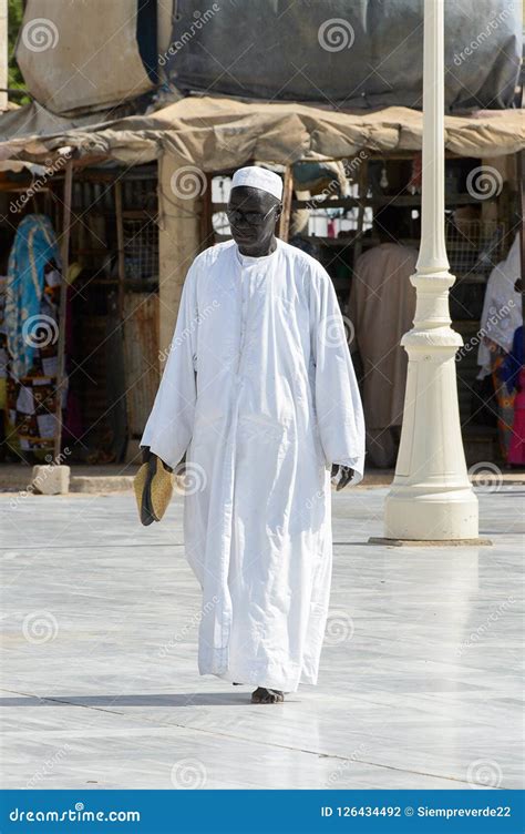 Unidentified Senegalese Man In White Traditional Clothes Walks