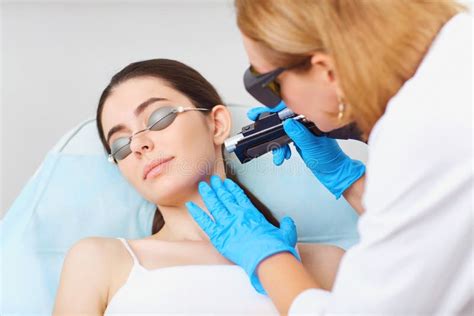 Laser Hair Removal On The Face Of A Young Woman In A Cosmetology Stock