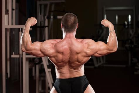 Premium Photo Bodybuilder Performing Rear Double Biceps Poses