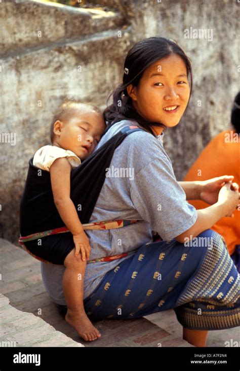 Mother Carrying Sleeping Child On Back Luang Prabang Laos Stock Photo