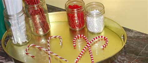 While we were working on our candy cane art, my son suggested that we make one to hang on our christmas tree. Easy candy cane ornament craft for small fingers | Simply Natural Mom