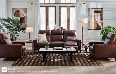 A Living Room Filled With Brown Furniture And Lots Of Pillows On Top Of