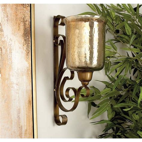 Made elegant by its simplistic details, this hanging sconce features a removable hurricane secured by a rounded frame. 20 in. x 11 in. Traditional Wrought Iron and Glass Wall ...