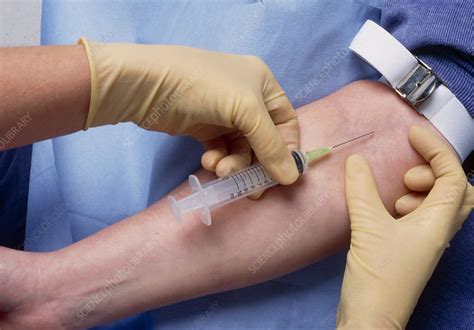 Gloved Hands Placing A Syringe In A Vein Stock Image M5320471
