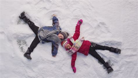 Two Kids In Winter Making Snow Angels Stock Footage Video 4583069