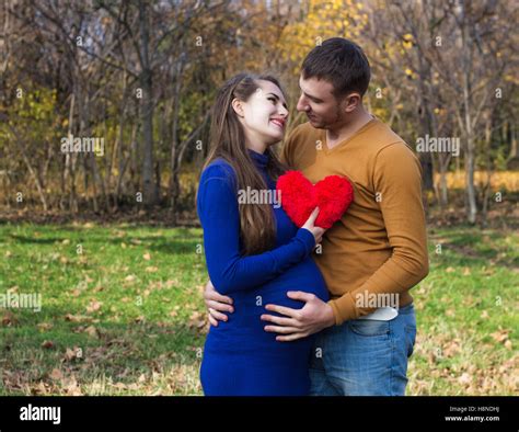 Happy Pregnant Couple Hugging Each Other She Holds A Soft Toy In The