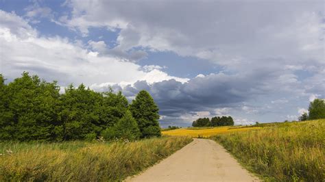 Road Path Between Grass Field Under Gray Clouds And Blue Sky 4k Hd