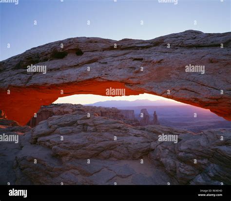 Usa Utah Canyonlands National Park Sunrise Reddens Underside Of Mesa