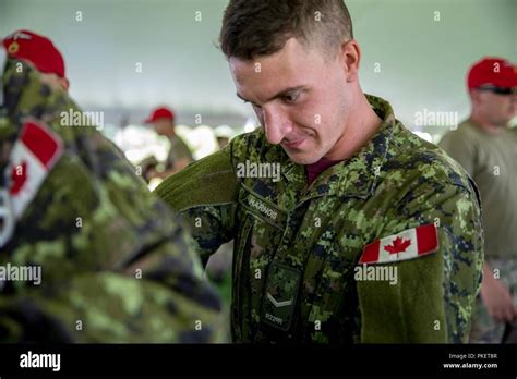 Canadian Paratrooper Pte Alex Harnois Assists Another Paratrooper With
