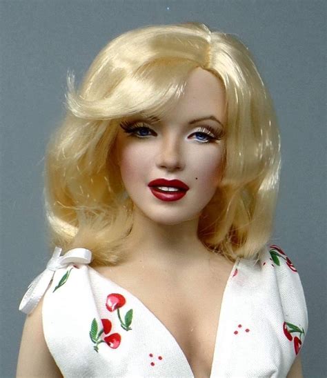 A Doll With Blonde Hair Wearing A White Dress And Red Lipstick On Its Lips