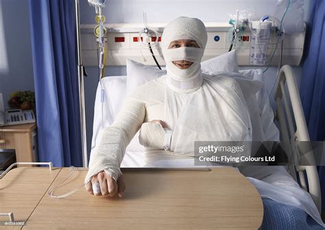 Man Lying In A Hospital Bed Covered In Bandages High Res Stock Photo