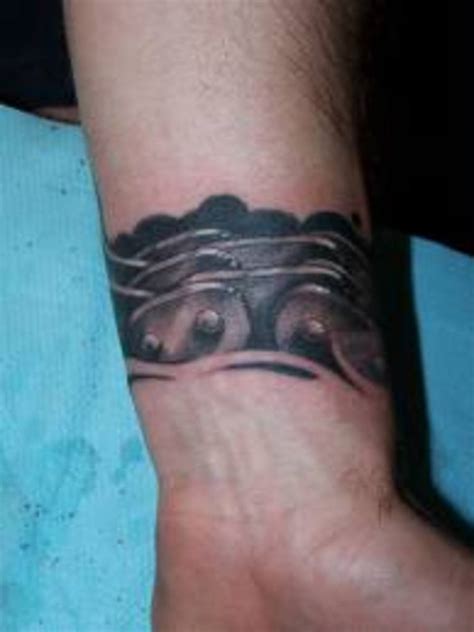 The chain itself can have small links in gold, silver, or even copper colors that wrap around the upper arm, and have a single strand of chain dangling down the length of the arm. Chain Tattoo Designs, Ideas, & Meanings | TatRing