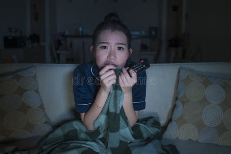 Young Beautiful Scared And Frightened Asian Japanese Woman Watching