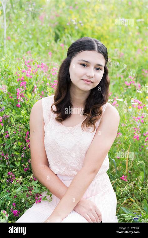 Pretty Girl Sits On Richly Meadow Stock Photo Alamy