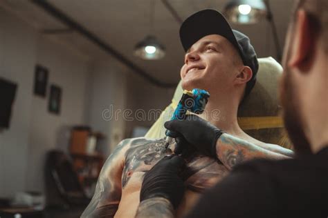 Handsome Man Getting A Tattoo At Alternative Art Studio Stock Image