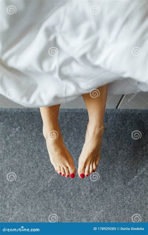 Slim Perfect And Beautiful Crossed Woman Legs On Bed Cropped Image Of Erotically Lying On Bed