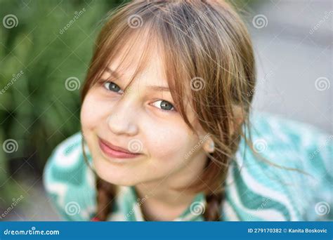 Close Face Portrait Of Young Blonde Teen Girl With Pigtails Posing