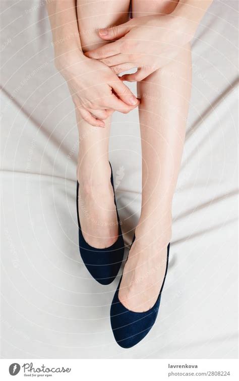 Above Shot Of White Woman Holding Her Legs In Shoes A Royalty Free
