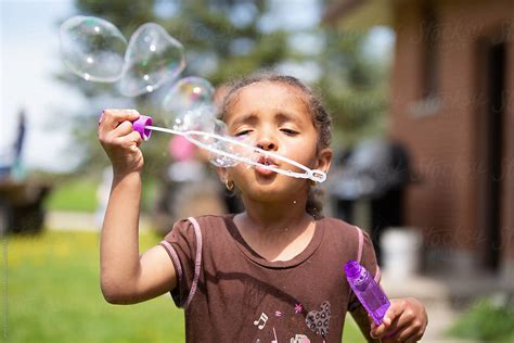 A Cute Young Child Blowing Bubbles By Stocksy Contributor Anya