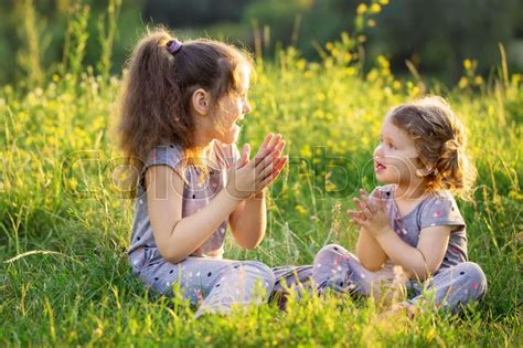 Two Children Talking And Having Fun On Stock Image Colourbox