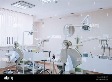 Dental Clinic Interior Design With Several Dentists Chair And Tools
