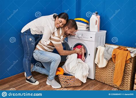 Man And Woman Couple Hugging Each Other Washing Clothes At Laundry Room Stock Image Image Of
