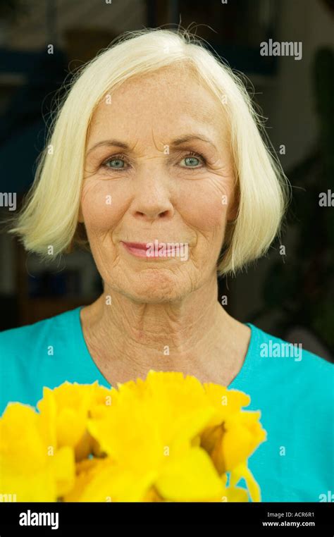 Senior Woman With Flowers Close Up Portrait Stock Photo Alamy