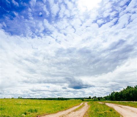 Rural Road In Green Grass Field Meadow Scenery Lanscape With Blue Sky