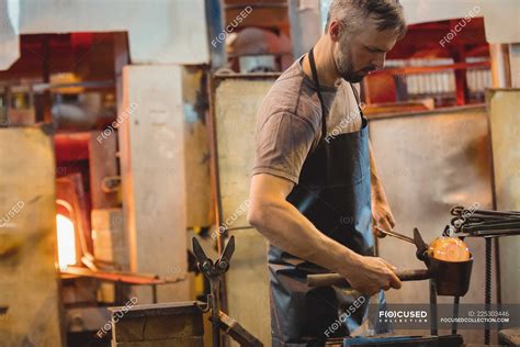 Glassblower Forming And Shaping A Molten Glass At Glassblowing Factory — Glassmith Hot Stock