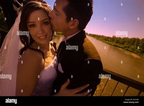 Groom Kissing Bride Stock Photo Alamy