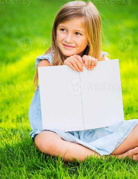 Little Girl Reading Book Outside 910021 Stock Photo At Vecteezy