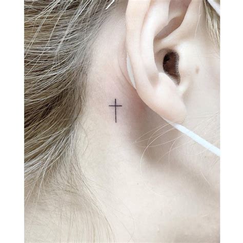 Minimalistic Cross Tattoo Done Behind The Ear