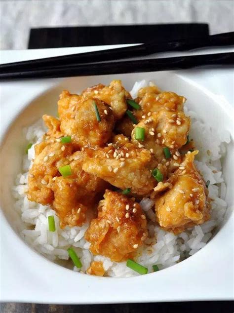 Place the fried chicken into a baking dish and pour the sauce over. Oven Baked Orange Chicken | RecipeLion.com