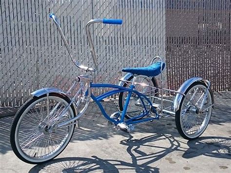 A Blue Bicycle Parked Next To A Fence