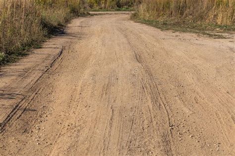 Dusty Dry Dirt Road With Wild Grass Thickets On Its Sides Stock Image