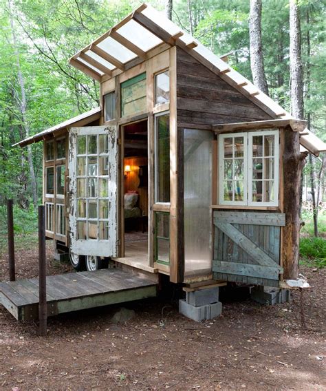 A Tiny House Built Into The Side Of A Forest