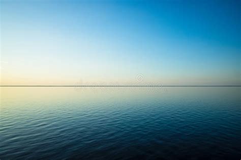 Tranquil Minimalist Landscape With A Smooth Blue Sea Surface With Calm