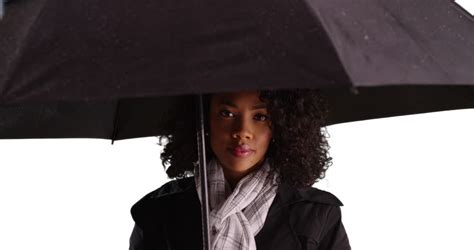 Portrait Of Pretty African American Woman Taking Shelter From Rain