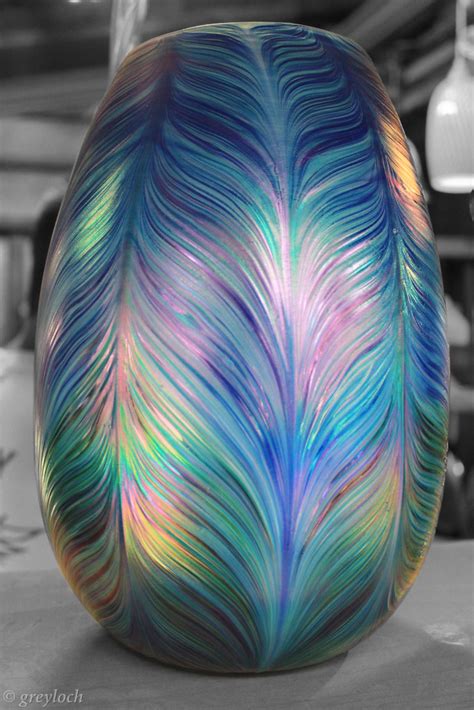 Peafowls belong to the pheasant family and are native to asia. peacock hand-blown glass vase | A close-up shot of a hand ...