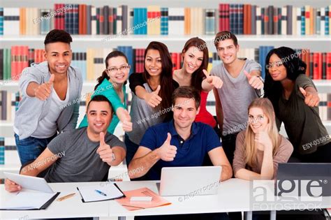 Group Portrait Of Multiethnic College Students Gesturing Thumbs Up Sign