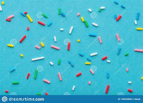Top Down Of Colorful Sprinkles Over Blue Festive Decoration For